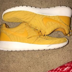 Yellow stitched Nike Roshe
